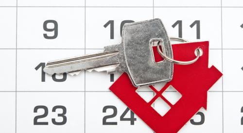 House key with calendar in background