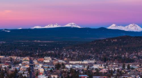 Bend, Oregon backdropped by Cascade mountains at sunset