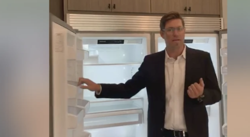 Thomas James Homes CEO Thomas Beadel shows off 6-foot freezer/fridge combo during Facebook open house tour. 