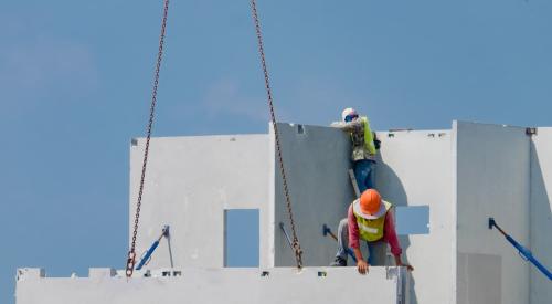 Workers installing concrete panels