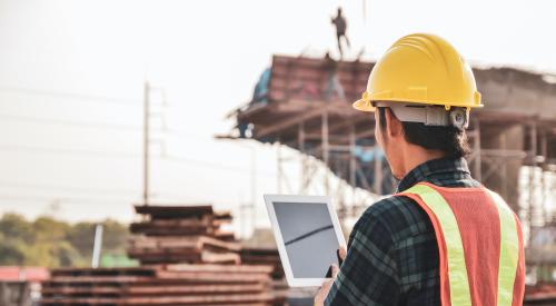 Construction worker with computer tablet