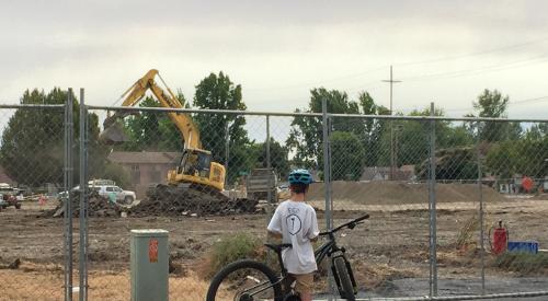 Kid watching construction 