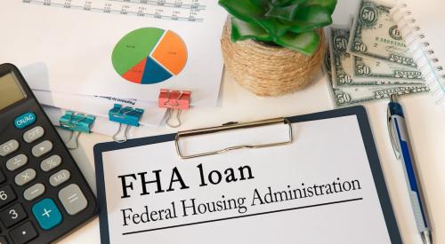 FHA loan paperwork on desk with calculator and statistics 