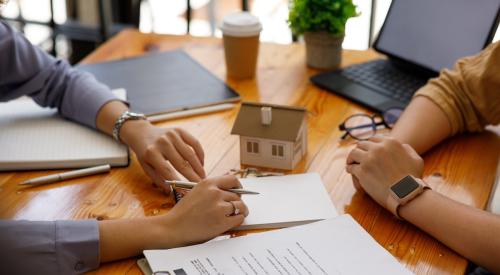 Real estate meeting with buyer signing papers