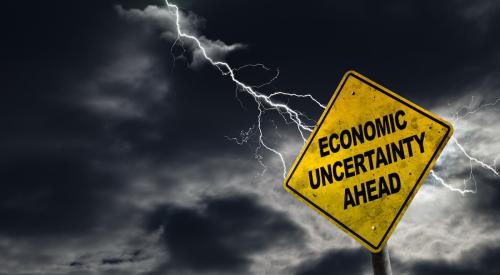 A yellow sign says 'Economic Uncertainty Ahead'