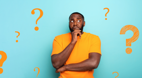 Man in orange shirt looking confused about the housing market