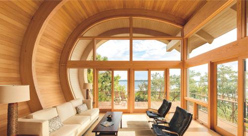 Wood windows and doors from Marvin installed in a home with a unique curved roof design