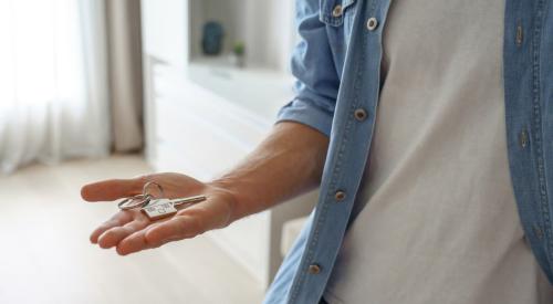 Millennial homeowner holding key