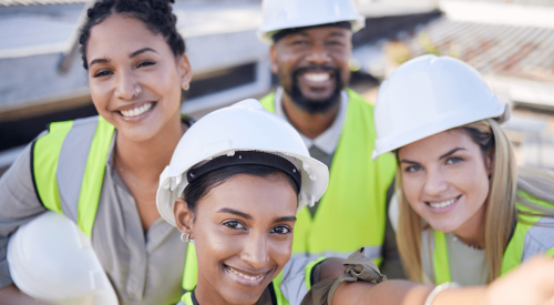 Group of smiling construction workers includes women and minorities