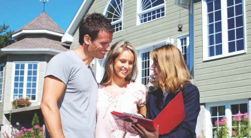 Young couple with salesperson buying a new home