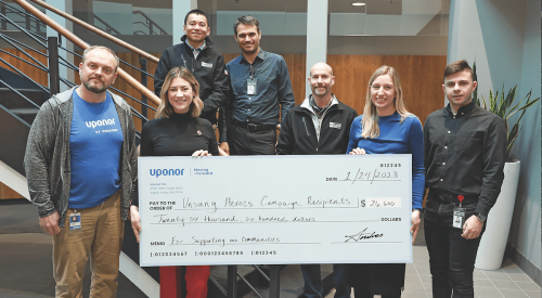 Uponor Unsung Heroes campaign presents a check to employees for volunteering