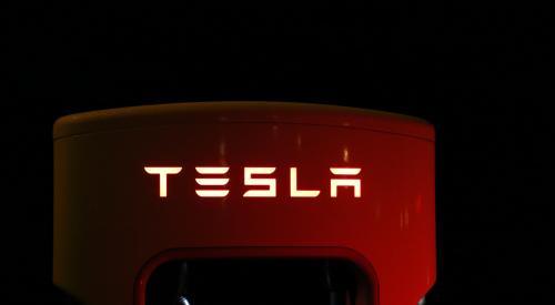 TESLA logo, red with yellow lettering on black background