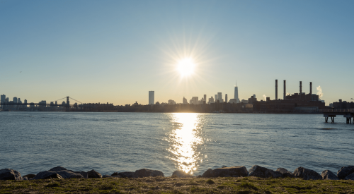 Shore of Transmitter Park in Greenpoint, Brooklyn, N.Y., along the East River with a view of the Manhattan skyline