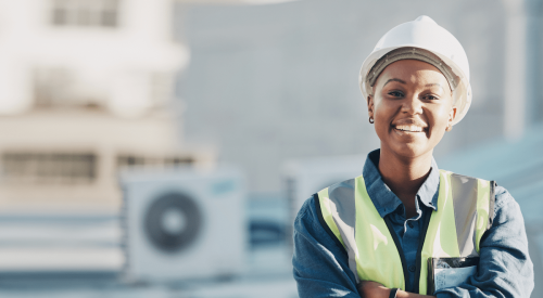 Woman construction worker wearing white hard hat on jobsite