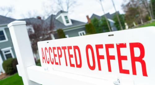 Accepted offer sign outside of for-sale house