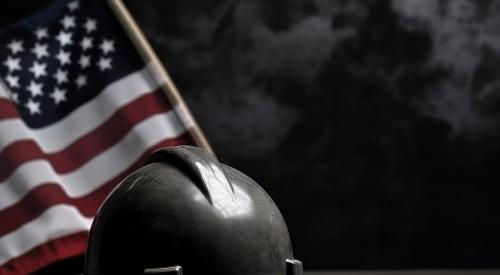 Black hard hat with American flag in background