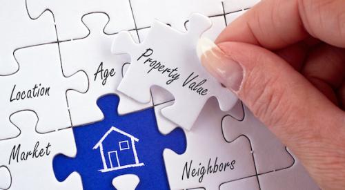 woman's hand moving "property value" piece on home appraisal puzzle 