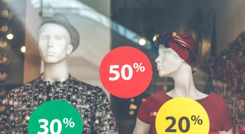 Mannequins with sale signs on store window