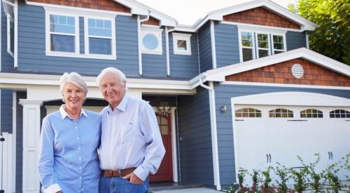 Baby Boomer homebuyers outside their new house