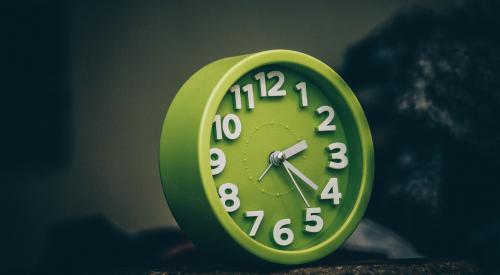 Green clock on table