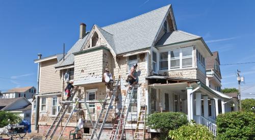 People remodeling exterior of beach house