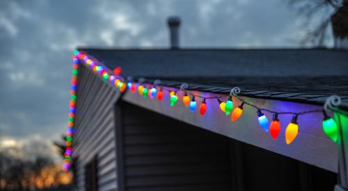 Single-family home with Christmas lights on roof