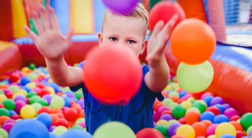 Boy in colorful ball pool