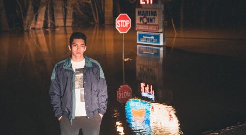 Man standing on flood street in the dark