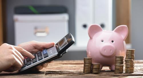 Hand calculator and a piggy bank