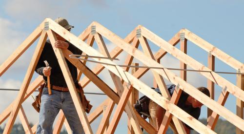 Builders framing roof on a new house