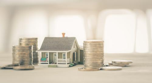 Small house in between stacks of coins