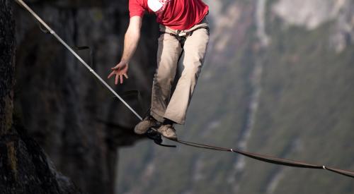 Person walking tightrope