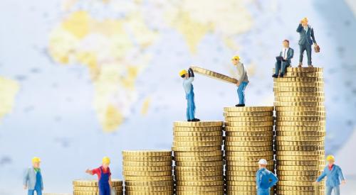 Small construction worker toys climbing on stacks of coins