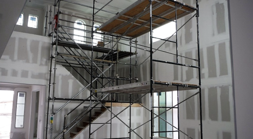 Safe interior scaffolding on a construction site uses guardrails