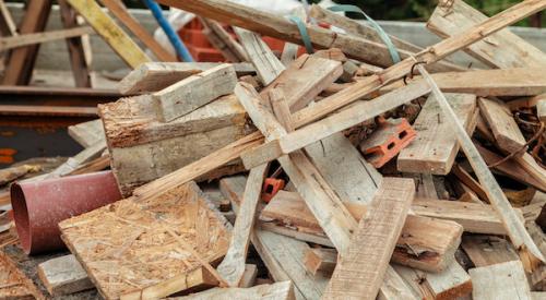 Plywood, lumber, and other construction waste in a pile on the jobsite