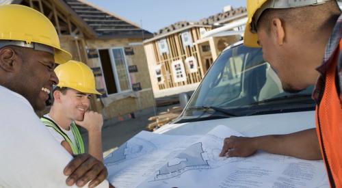 Construction workers with house plans