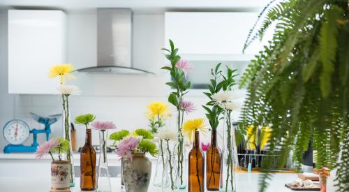 Kitchen with flowers in vases on table