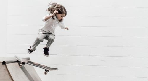 Child skateboarding down a ramp