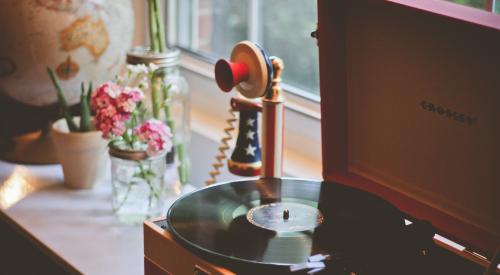 Table with record player and red white and blue phone