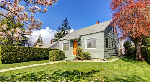 Small entry-level starter home with a large front lawn