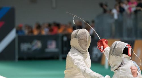 Two people fencing