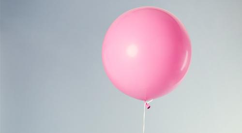 Chair with pink balloon tied on