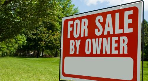 For sale by owner sign on residential lawn