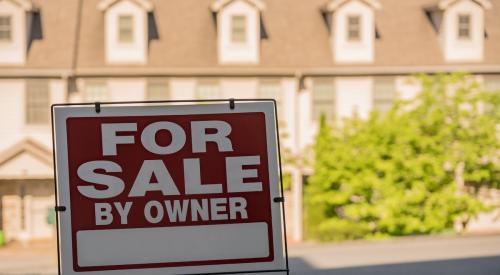 For sale by owner sign outside of residential property