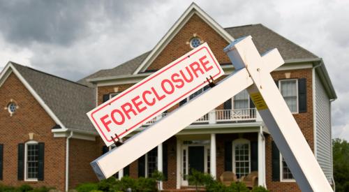 House with foreclosure sign