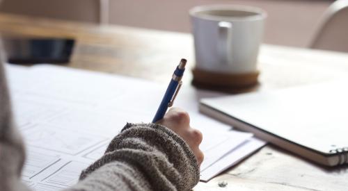 Woman writing on paper