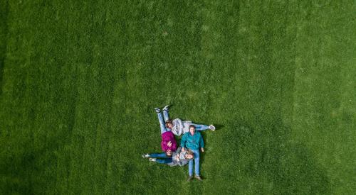 Family lying in grass