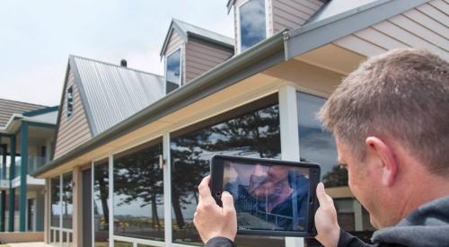 Home builder using a tablet for a virtual inspection