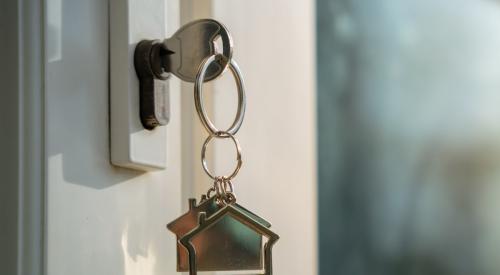 House key dangling from front door lock