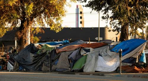 Tents crowded by the road in a homeless encampment